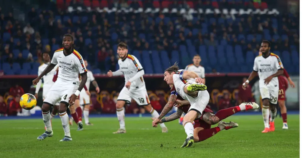 Lecce players are attempting to score against Roma