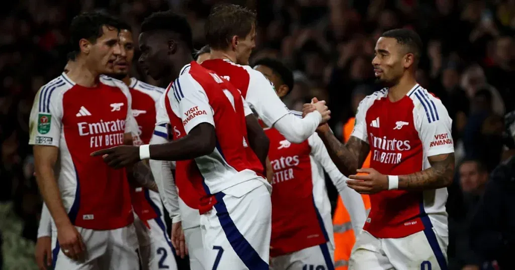 Arsenal players celebrating after scoring a goal against the Eagles