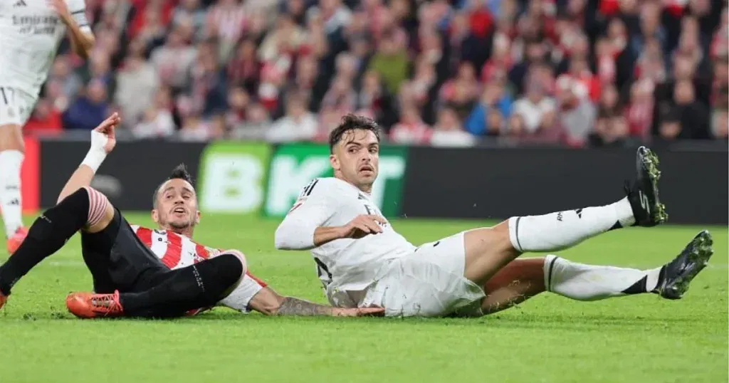 Raul Asencio sporting blacked-out Skechers boots.